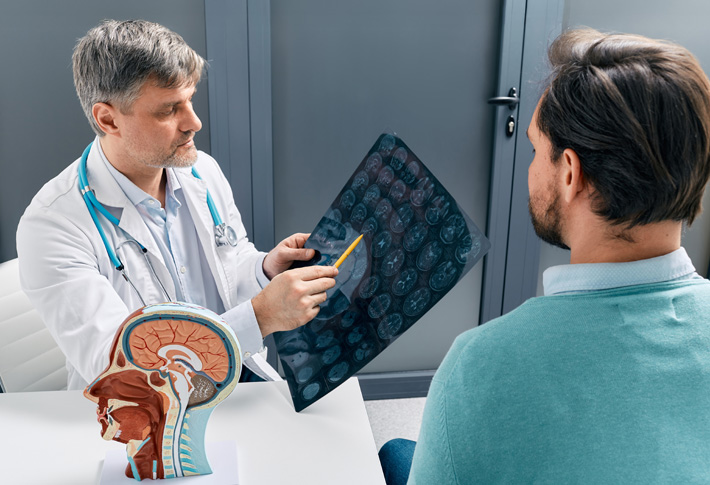 Radiologist reviewing brain scan results with a patient